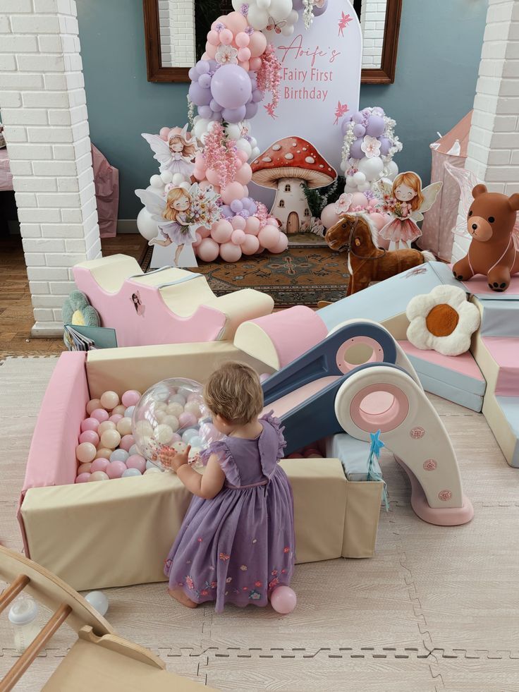 Fairy first birthday party with soft play ball pit, foam climbers and balloon arch setup